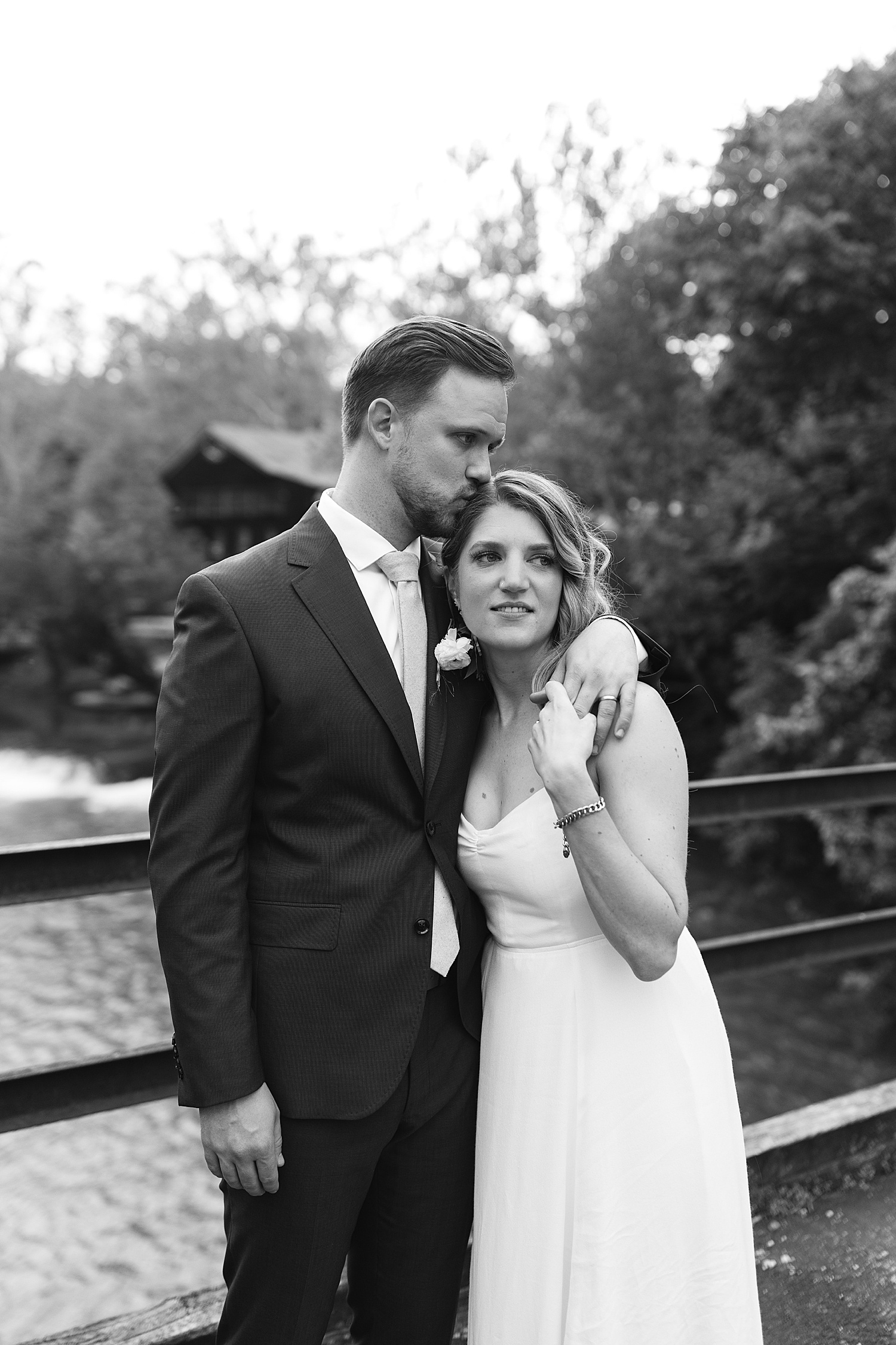 Black and white photo of wedding couple looking off into the distance