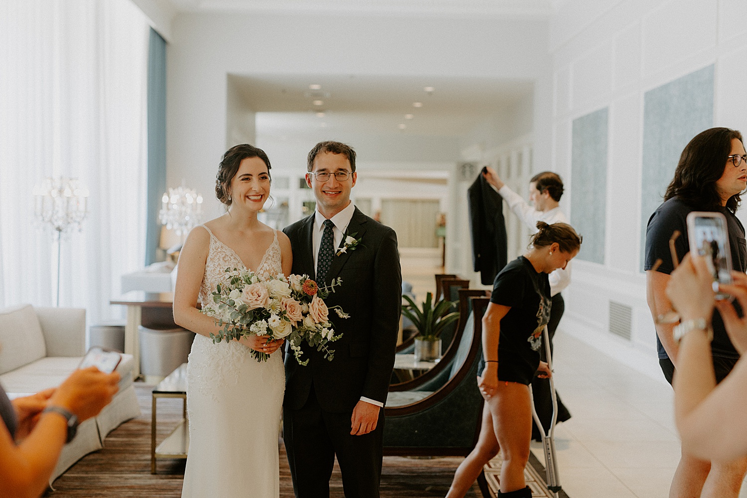 Couple standing together getting picture taken by friend