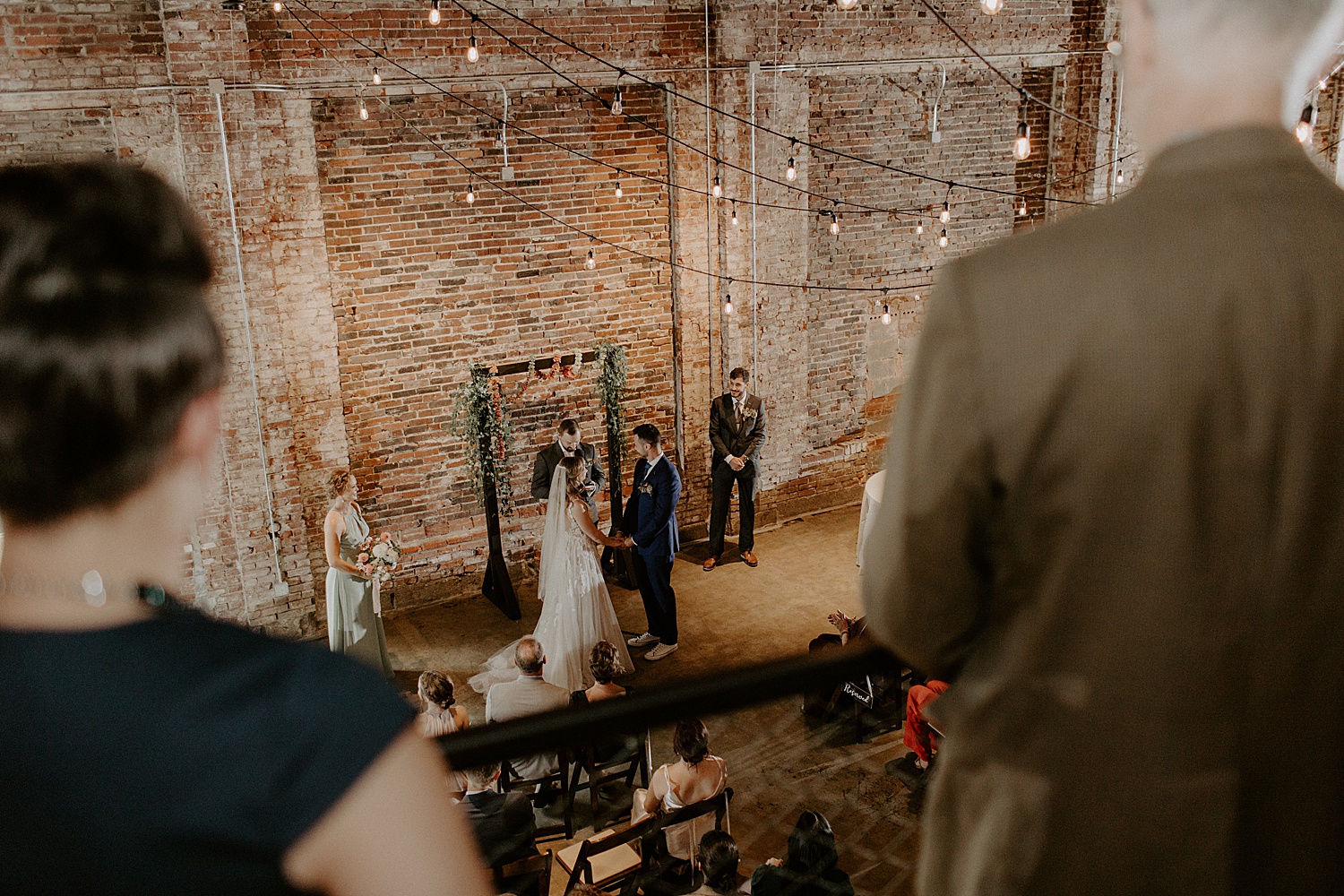Couple standing together during ceremony at Wild Carrot