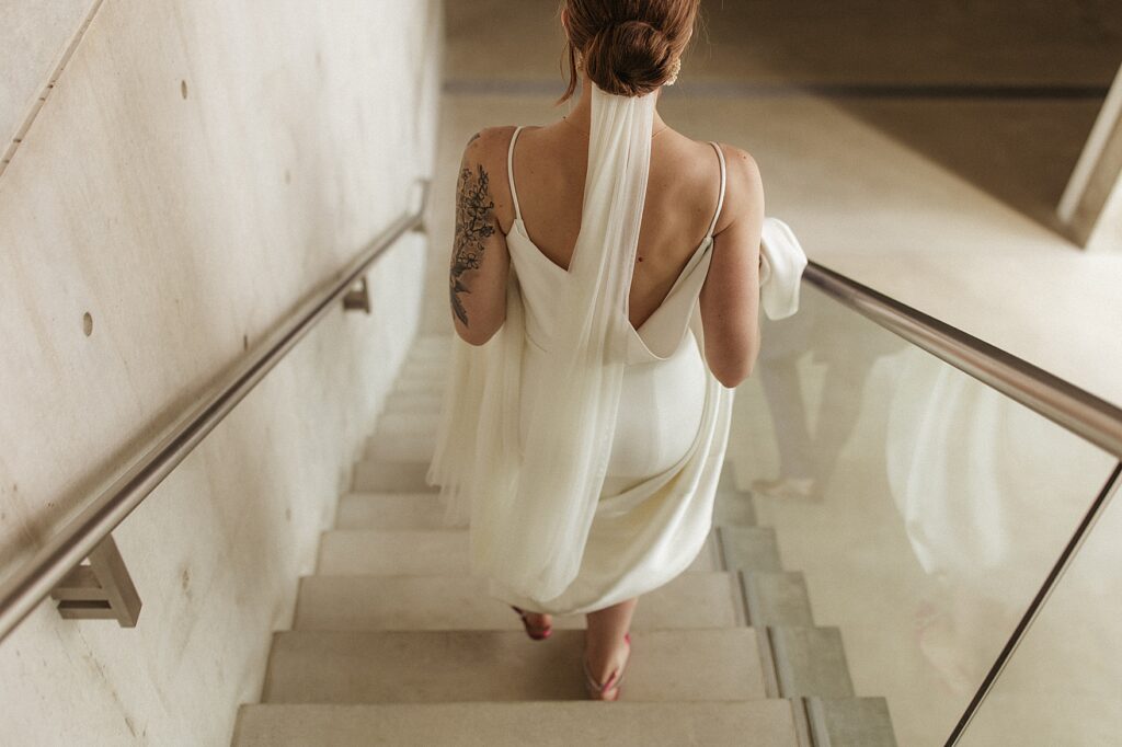 Bride walking down stairs at Pulitzer Arts Foundation in St. Louis, MO