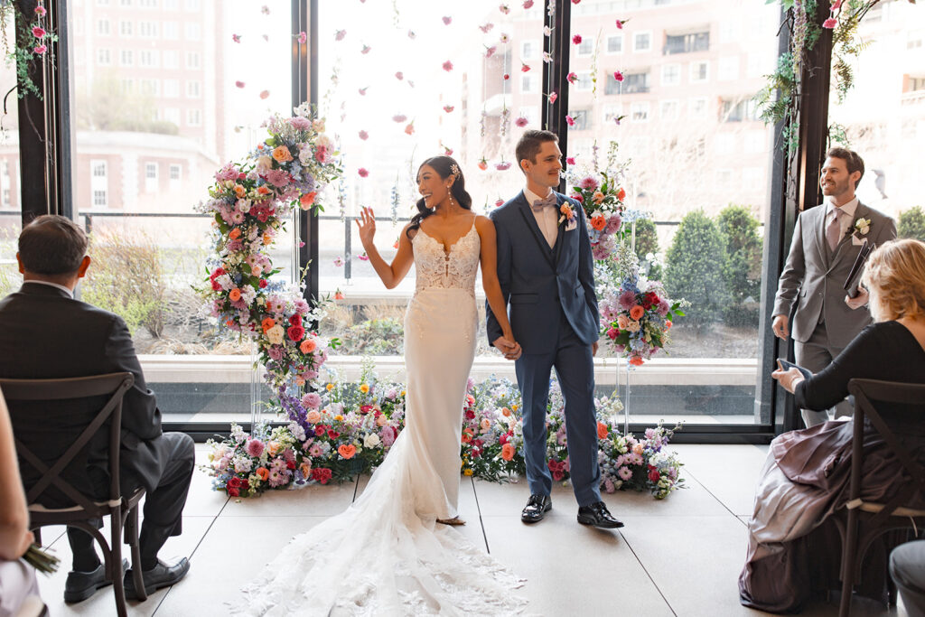 Bride and groom wave to guests curing ceremony at the Ritz-Carlton St. Louis