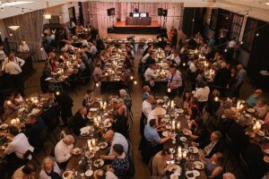 Image of aerial view of guests dining at The Hall at Olive + Oak in Webster Groves during a wedding reception.