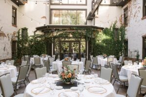 Tables with florals in the courtyard of the Seven Gables Inn hotel in Clayton, Missouri