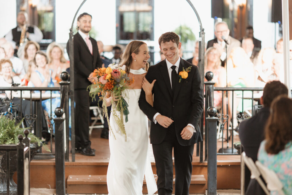 Bride and groom looking excited after their wedding ceremony at The Lemp Mansion.