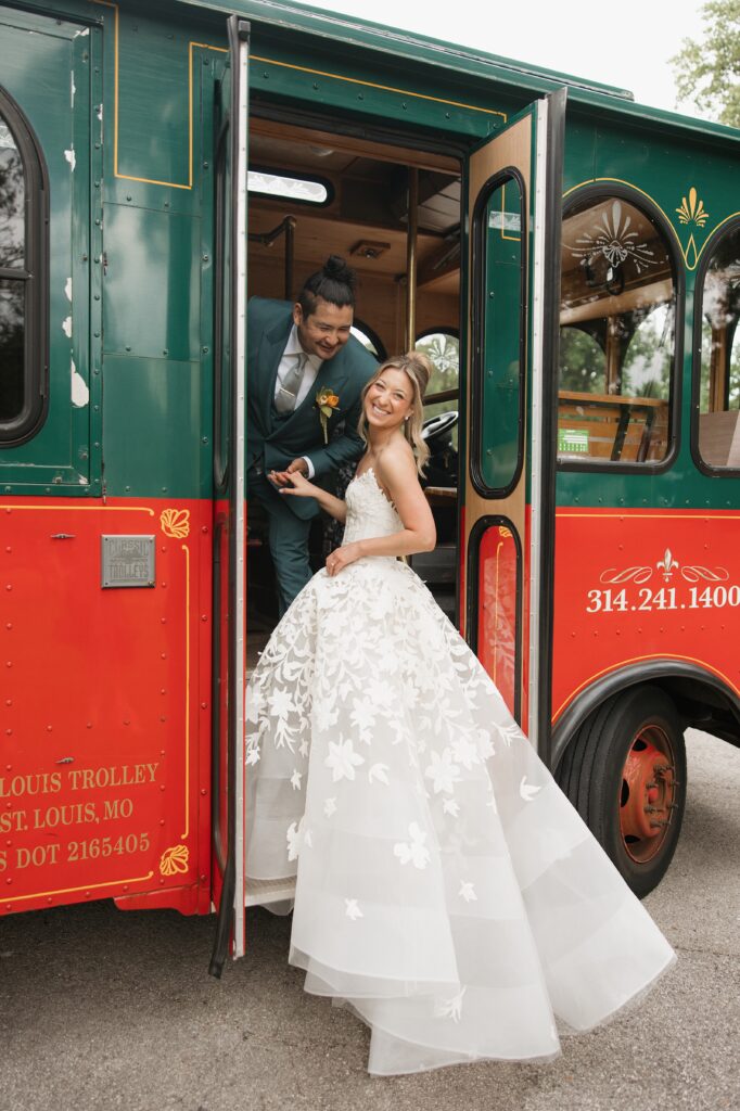 Julie and Nick in front of St. Louis trolley on their wedding day.