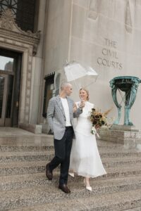 Olivia and Zach outside the St. Louis courthouse after their rainy courthouse wedding